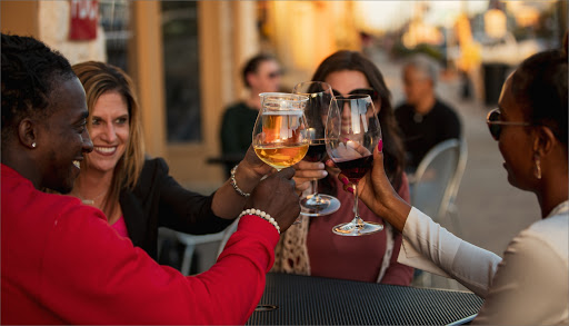Friends clinking wine glasses in Denison, Texas